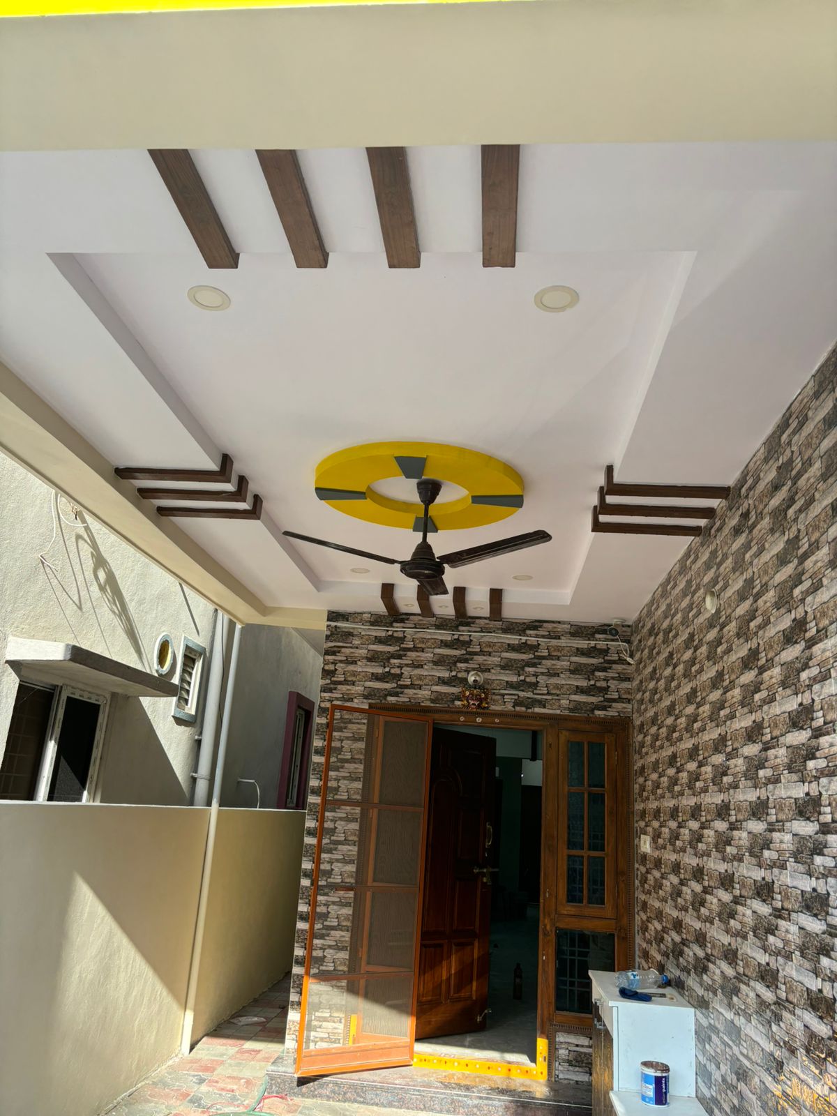 Exterior Entrance with Stone Texture and False Ceiling