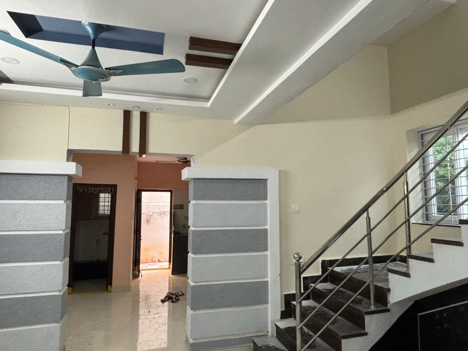Staircase Area with Textured Walls and Modern Ceiling